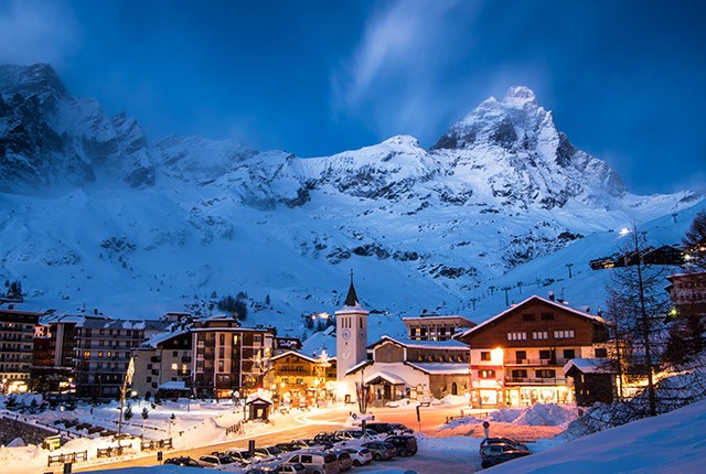 Best snowboarding resorts in Europe; Cervina, Italy, night village.