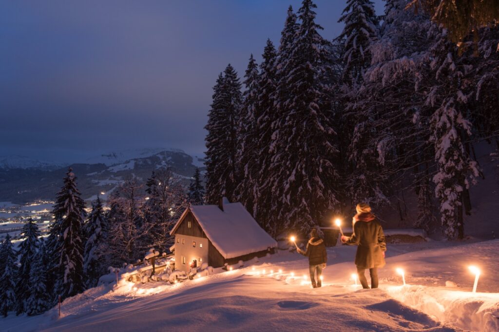 A candle lit hike on a snowy mountain