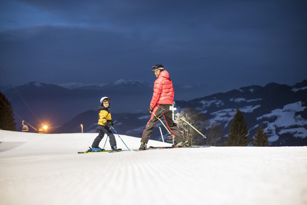 A father and son night ski together