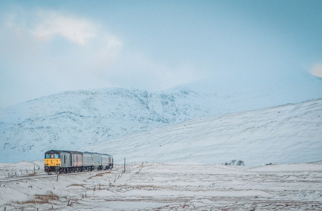 Train going through snowy Scottish countryside