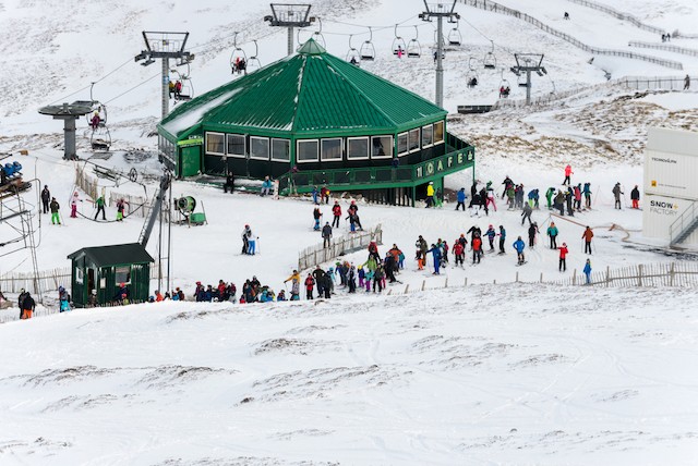 Skiiers at Glenshee in Scotland beneath chairlifts