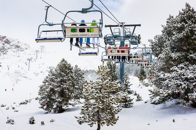 Chairlift above snowy trees. Skiing in Andorra