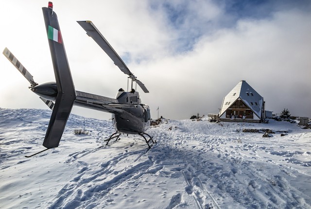 Helicopter in the Alps with Italian flag