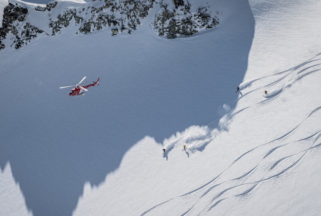 Helicopter above skiers in Zermatt